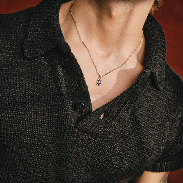 Model wears a chunky black knitted t-shirt with the Silver Abyssal Necklace - Serge DeNimes