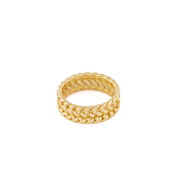 Gold ring with braided design on a white background