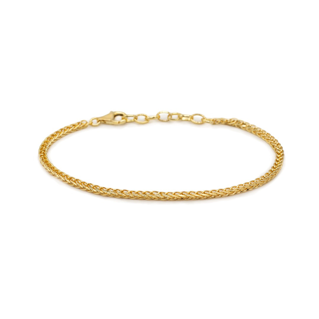 Gold Spiga chain bracelet on white background