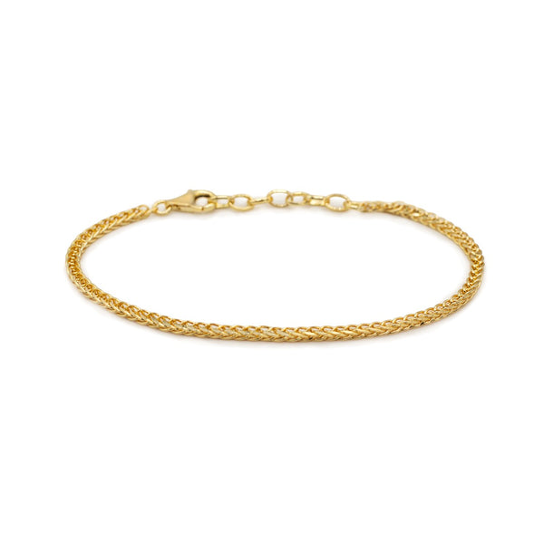 Gold Spiga chain bracelet on white background