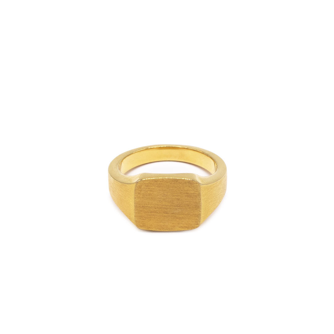 Gold plated Silver ring with square shaped face and heavily brushed finish on a white background