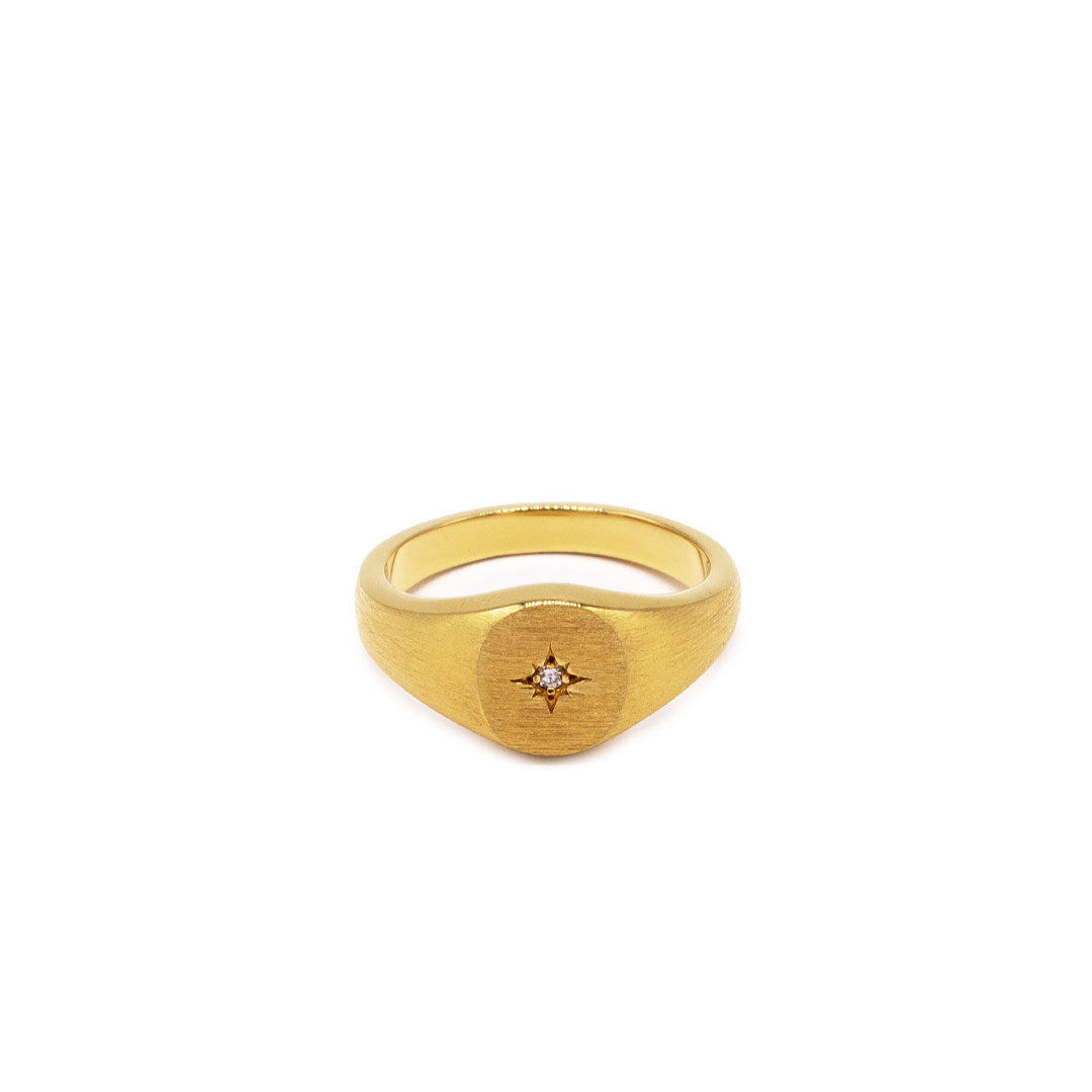 Gold plated Silver signet ring with star setting and diamond gemstone on the face and a heavily brushed finish