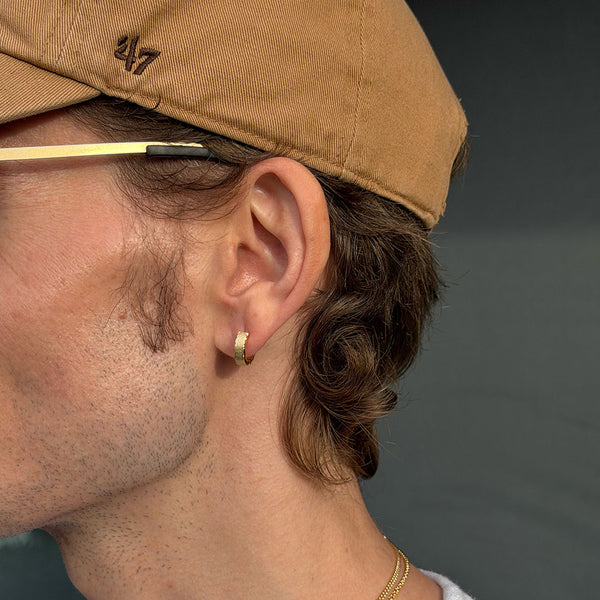 Male model wearing Gold Forge Earring in ear lobe