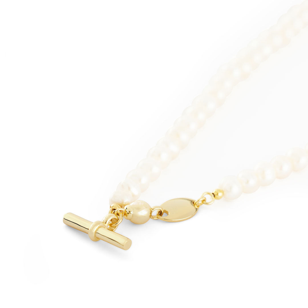 Pearl necklace with Gold t-bar on white background
