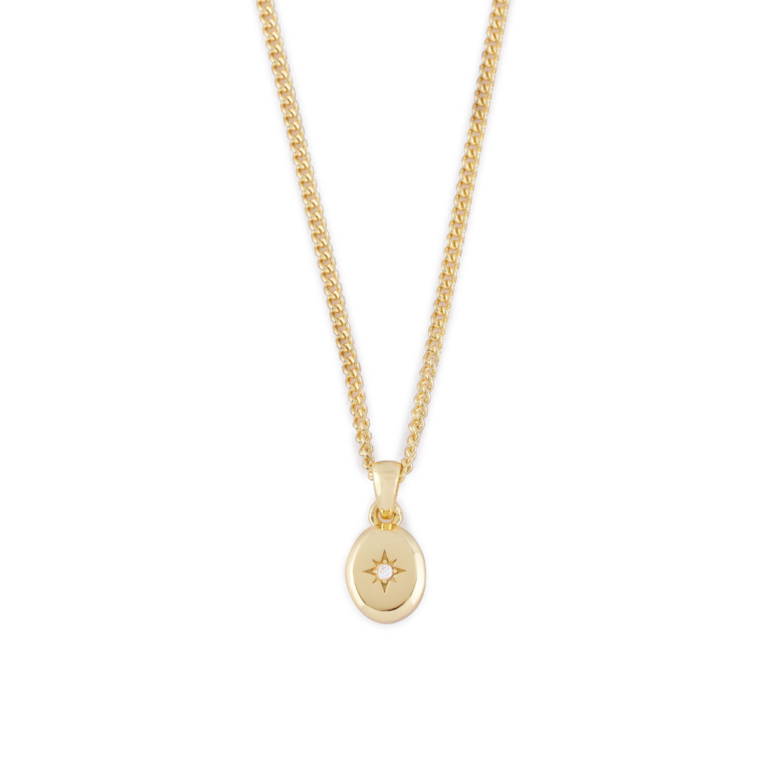 Gold curb chain with oval pendant, star setting and clear gemstone - Serge DeNimes