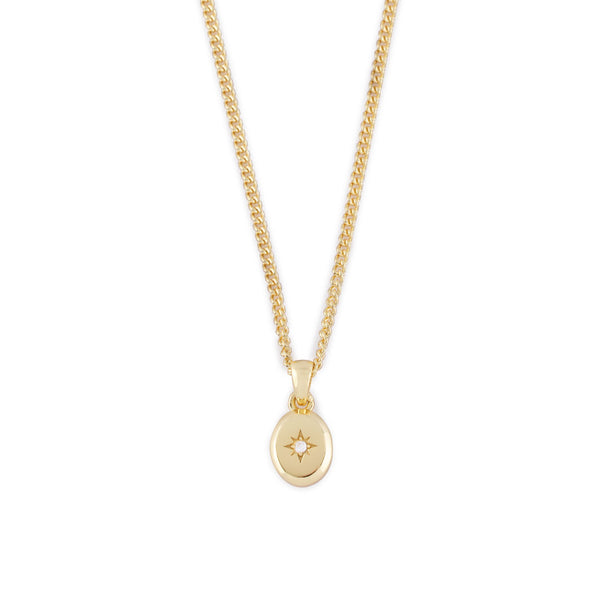 Gold curb chain with oval pendant, star setting and clear gemstone - Serge DeNimes
