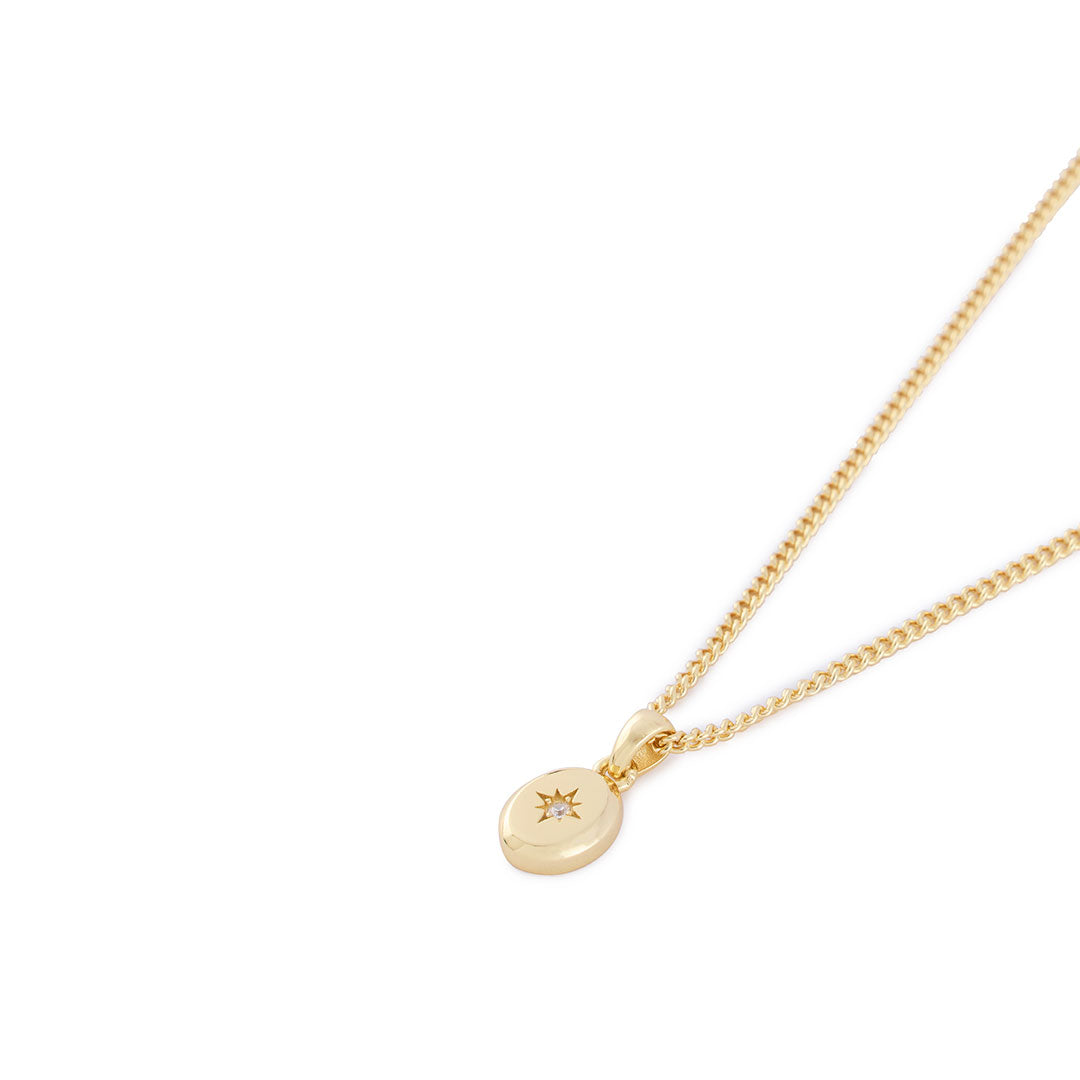 Gold curb chain with oval pendant, star setting and clear gemstone - Serge DeNimes