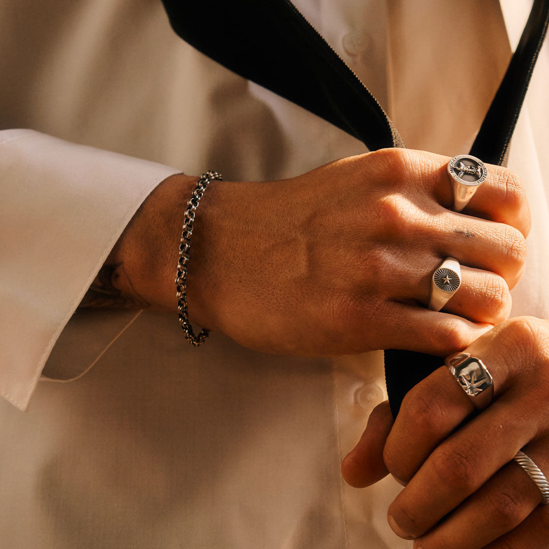 Close-up of a person's hands with visible jewellery and a Silver chain bracelet by Serge DeNimes