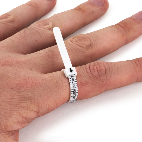 Models hand using the Ring Sizer, showing the ring size being indictated - Serge DeNimes