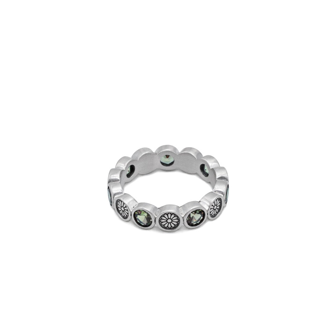 Silver ring with embedded stones on a white background