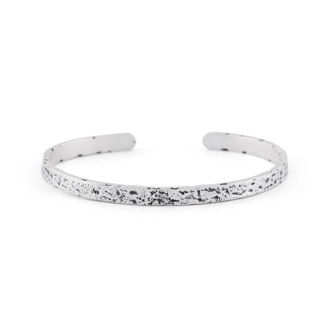 Silver cuff bracelet with very rough texture and oxidisation