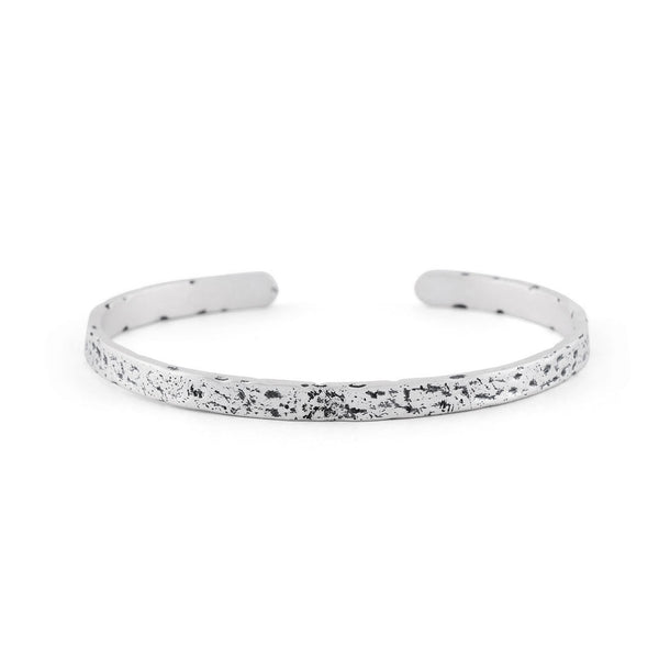 Silver cuff bracelet with very rough texture and oxidisation