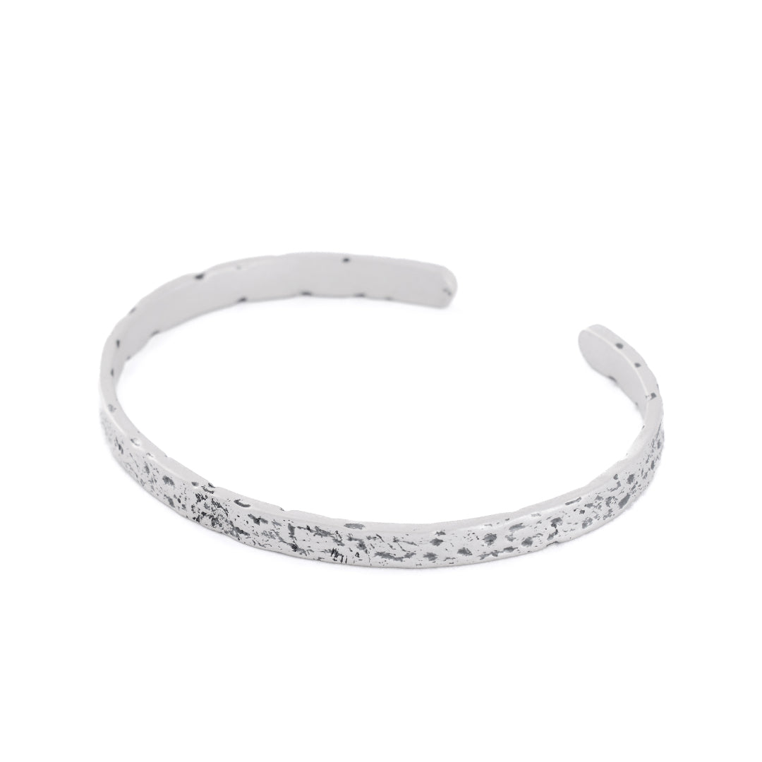 Silver cuff bracelet with very rough texture and oxidisation