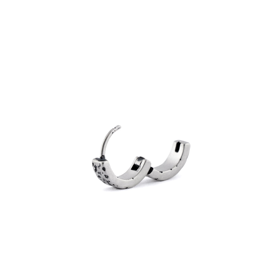 Sterling Silver huggie earring with rough texture in closed position