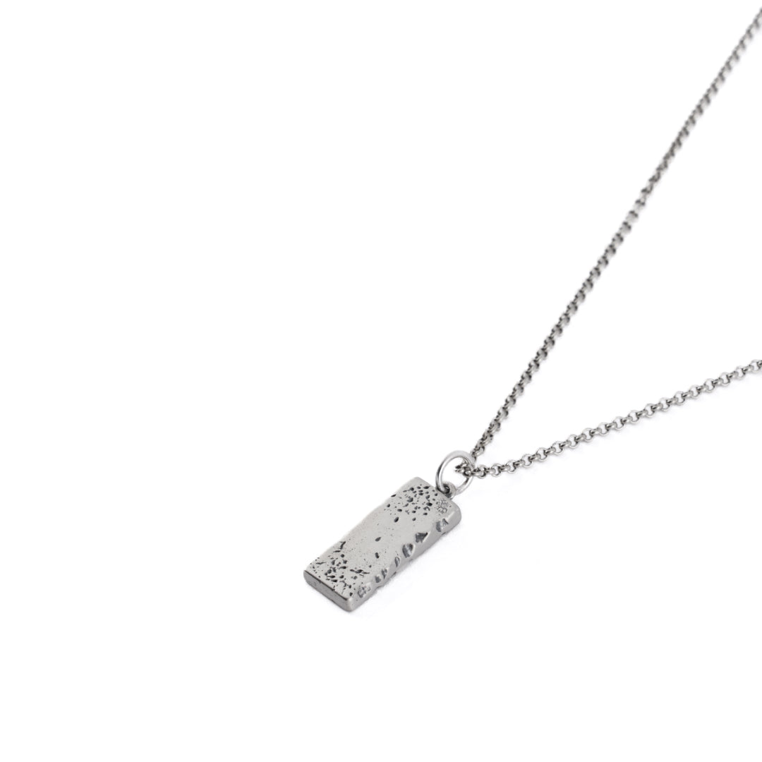 Silver necklace with long rectangular pendant with very rough texture and heavy oxidisation - Serge DeNimes