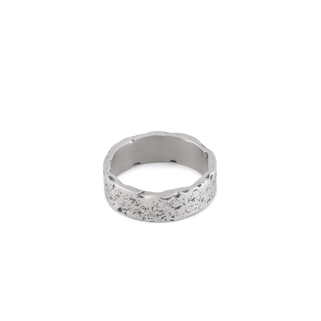 Silver band ring with very rough texture and oxidisation on outside and smooth inside