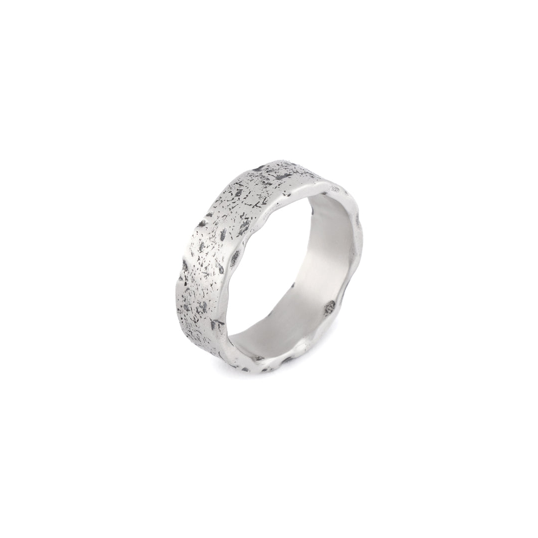 Silver band ring with very rough texture and oxidisation on outside and smooth inside