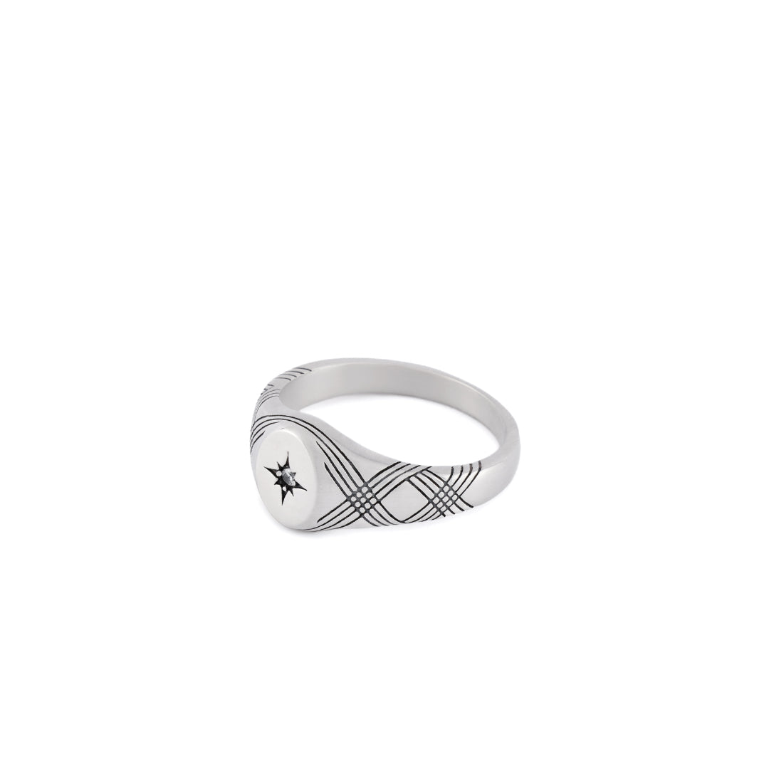 Silver signet ring with line detailing across the ring body with a star setting and clear gemstone - Serge DeNimes