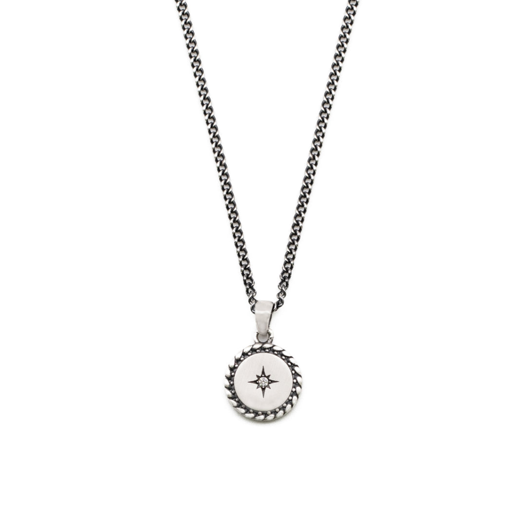 Silver necklace with slim curb chain and round pendant with diagonal border, star setting and clear gemstone - Serge DeNimes