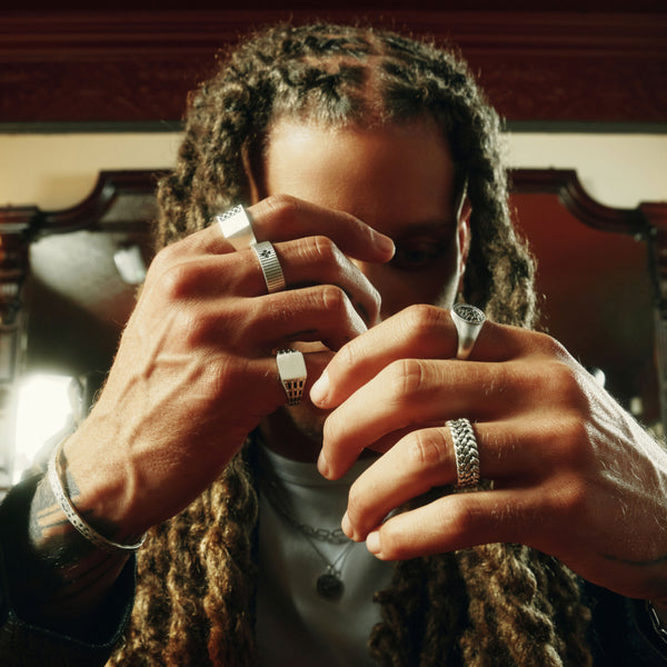 Person with multiple rings on fingers in a close-up shot