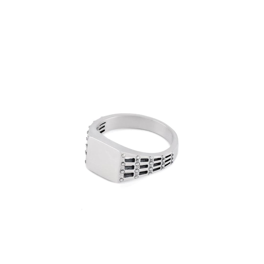 Silver ring with small square face and a cut out stud and grid effect on the shoulders - Serge DeNimes