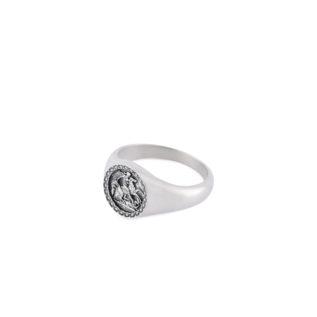 Silver ring with round face, diamond pattern border with St George riding a horse detailing - Serge DeNimes