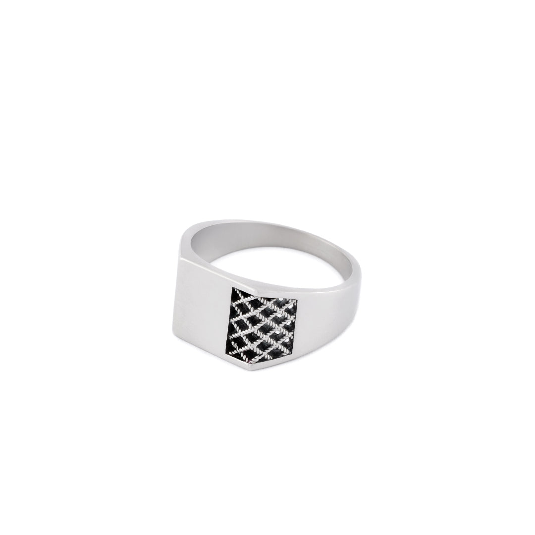 Silver ring with a chunky square face has cut out grid detailing on one side - Serge DeNimes