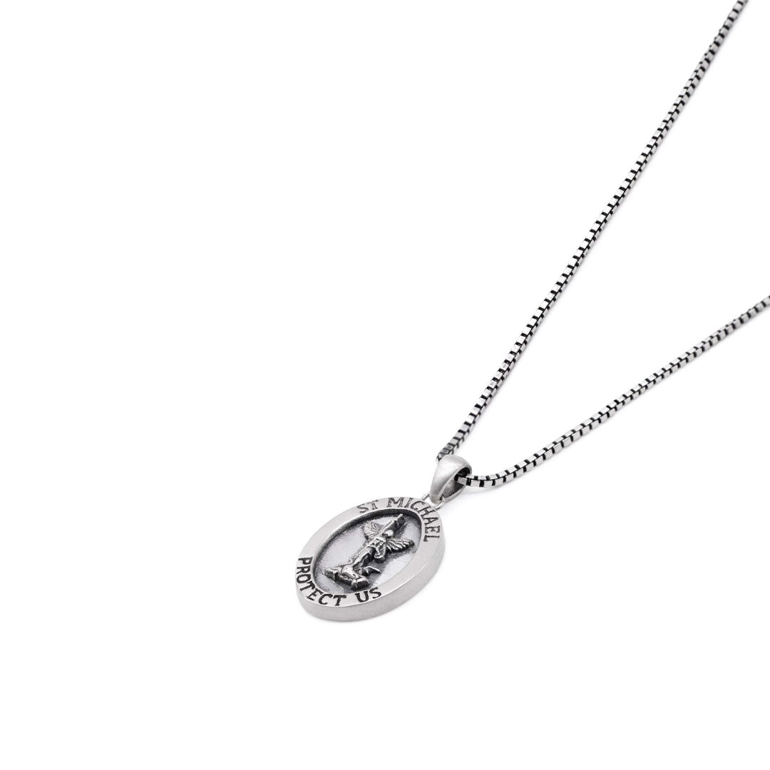 Silver necklace with an oval shaped pendant with a depiction of St Michael