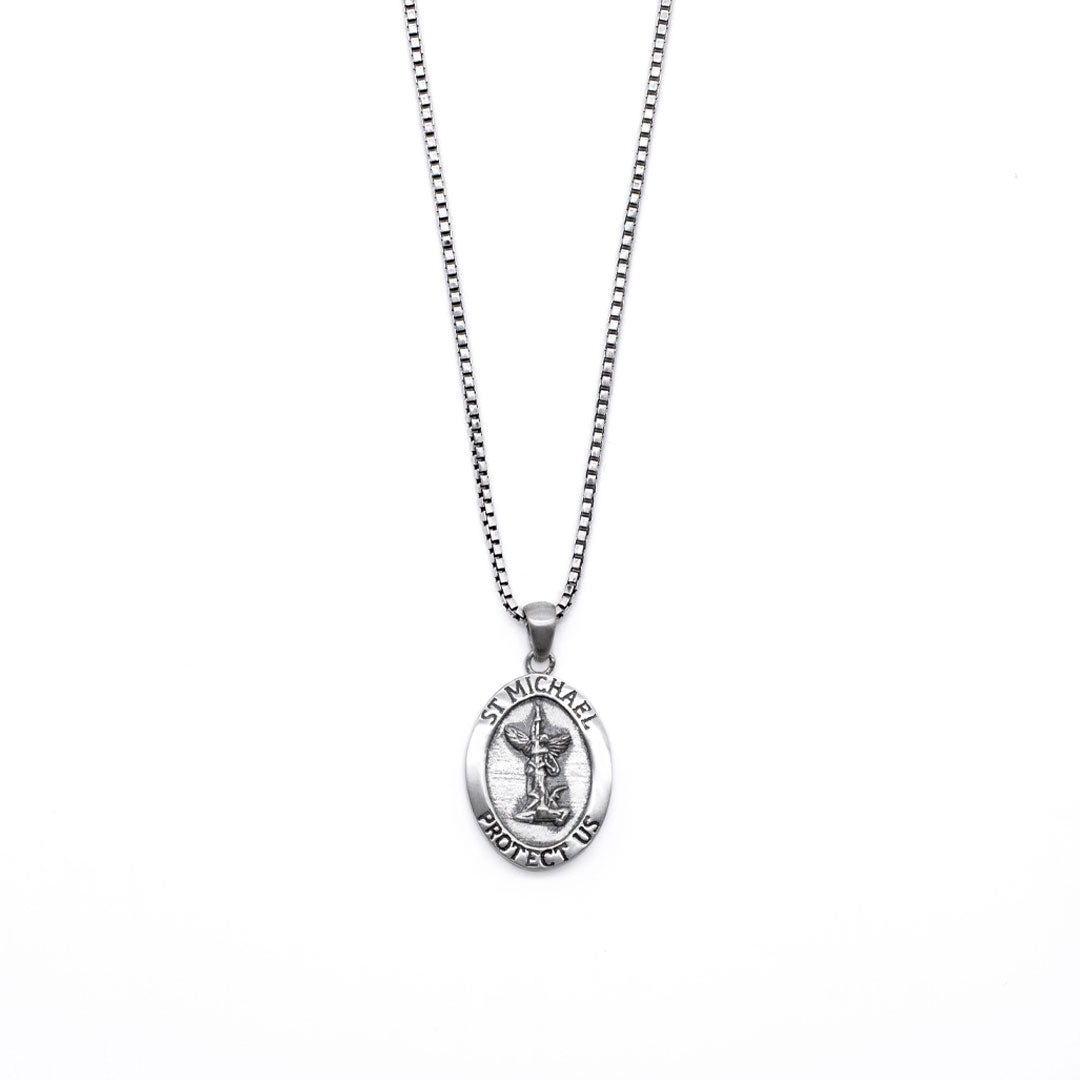 Silver necklace with an oval shaped pendant with a depiction of St Michael