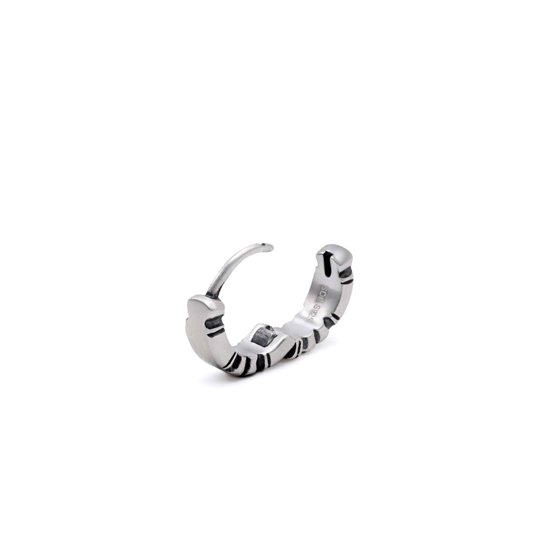 Silver Huggie Earring with shapely edges by Serge DeNimes in an open pose