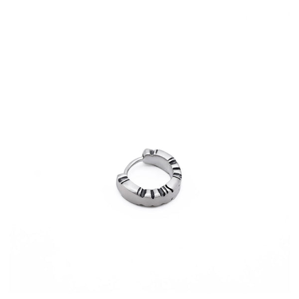 Silver Huggie Earring with shapely edges by Serge DeNimes in a closed pose