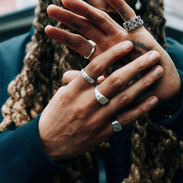 Male model hands wearing multiple Silver rings