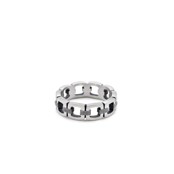 Silver chain-link ring on a white background by Serge DeNimes