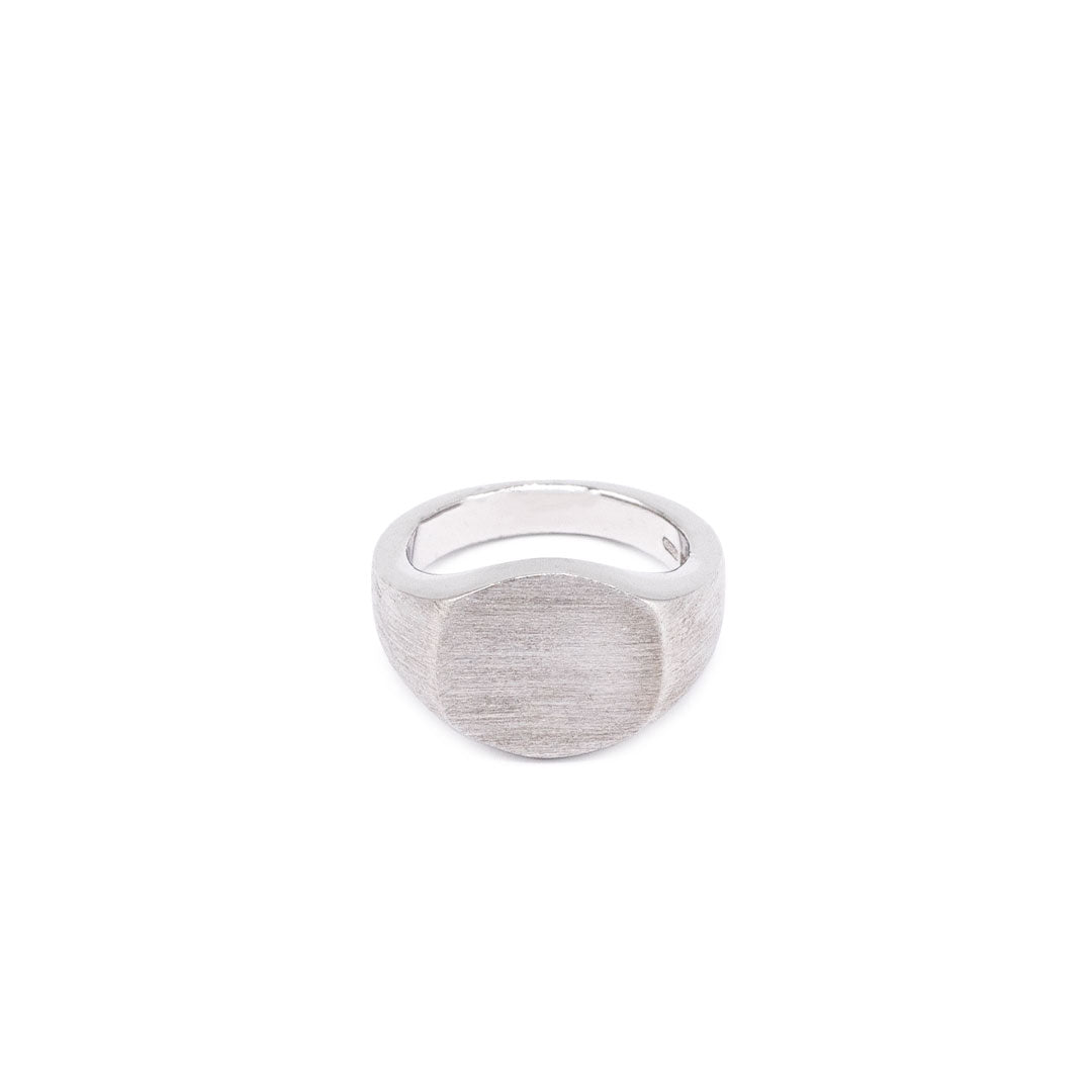Silver ring with Round shaped face and heavily brushed finish on a white background