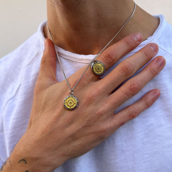 Model wearing a white t-shirt with their hand up and the necklace resting on it with matching Compass Ring & Necklace