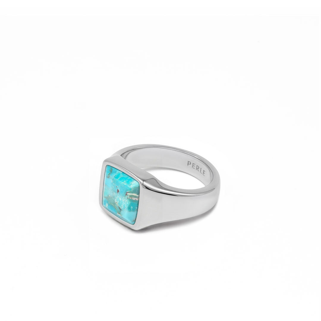 Silver ring with large turquoise stone on a white background