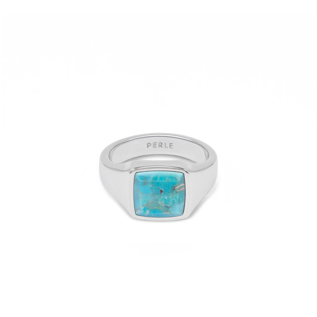 Silver ring with large turquoise stone on a white background