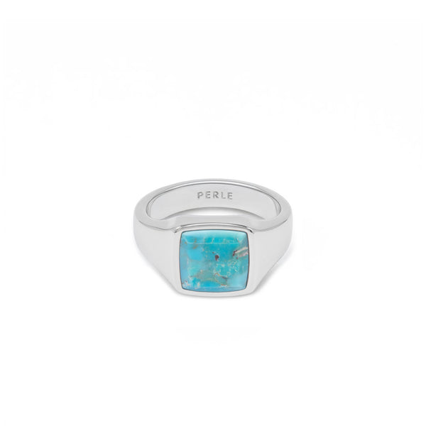 Silver ring with large turquoise stone on a white background