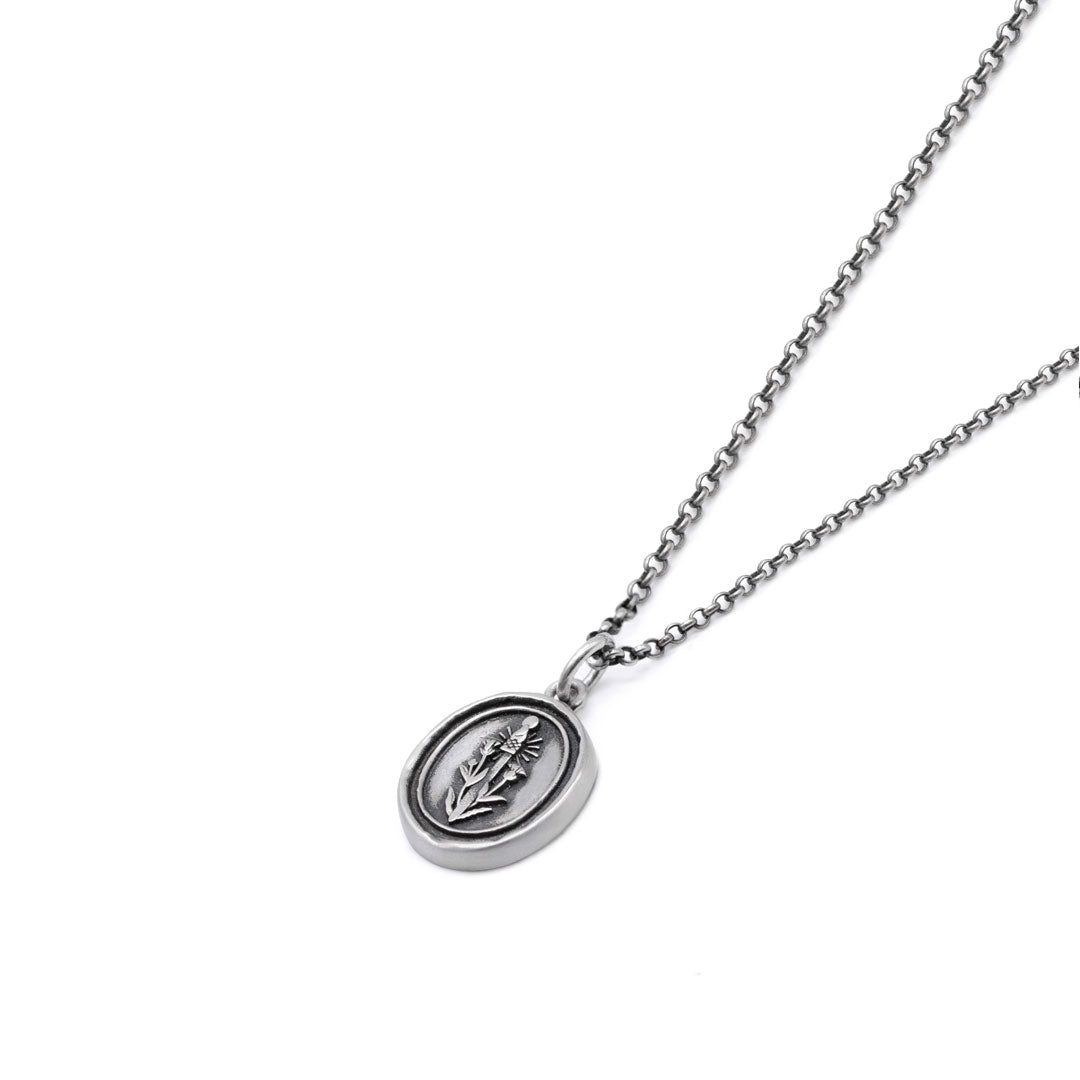 Silver necklace with an oval shaped pendant with a thistle & swords on it