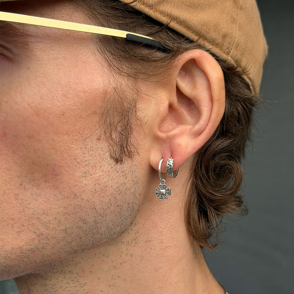 Male model wearing Clement Earring and Forge Earring in his ear lobe