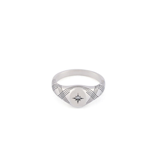Silver signet ring with line detailing across the ring body with a star setting and clear gemstone - Serge DeNimes