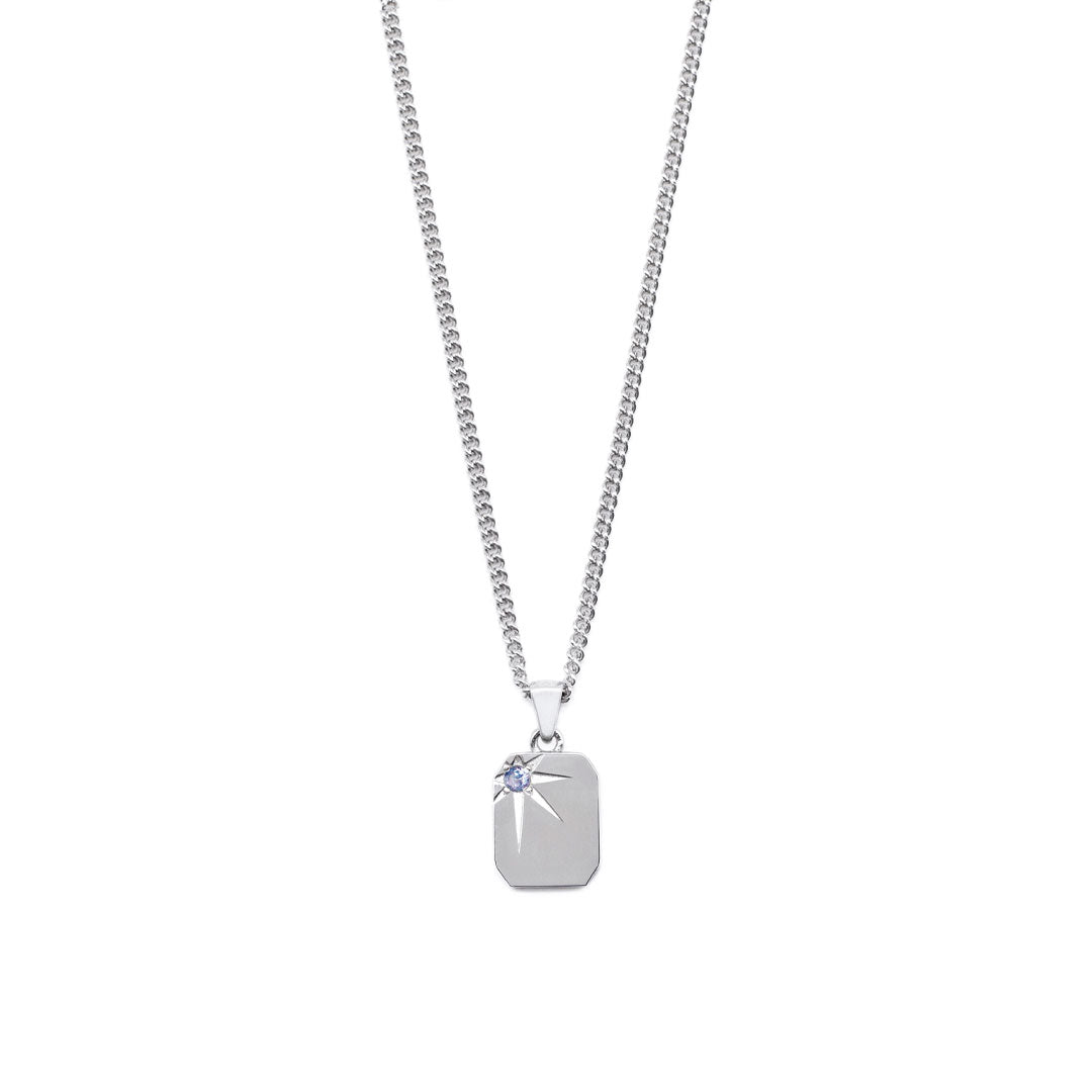 Silver necklace with a rectangular pendant, oversized star setting and pale blue gemstone