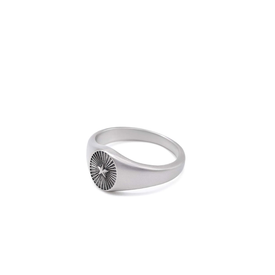 Silver signet ring with a star & ridged background by Serge DeNimes
