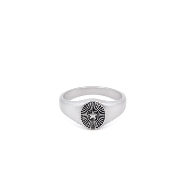 Silver signet ring with a star & ridged background by Serge DeNimes