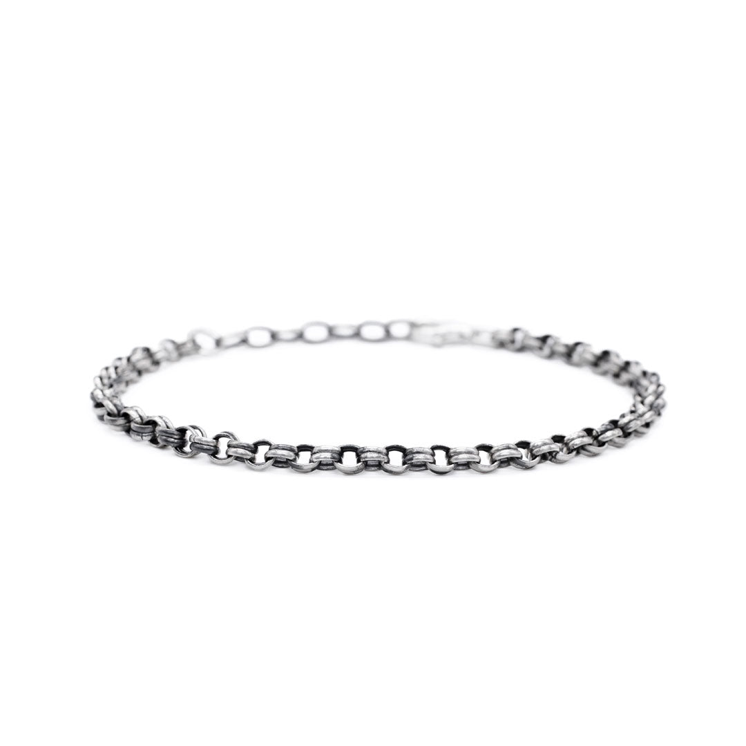 Silver chain bracelet on a white background by Serge DeNimes