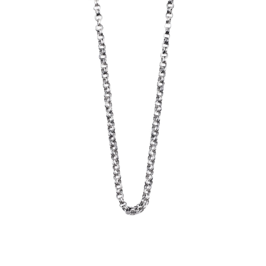Silver neck chain on a white background by Serge DeNimes