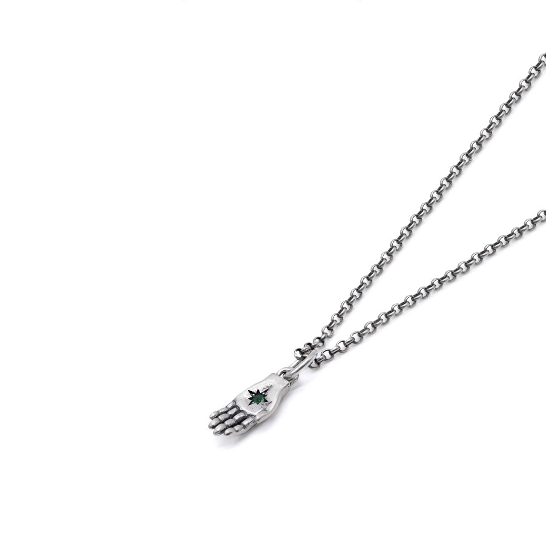 Silver hand-shaped pendant necklace with a green gemstone on a white background