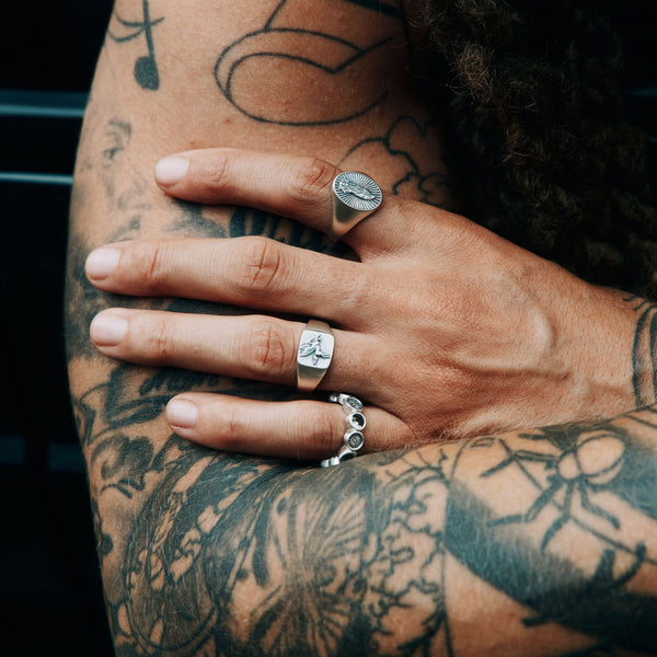 Male model hand wearing 3 Silver rings