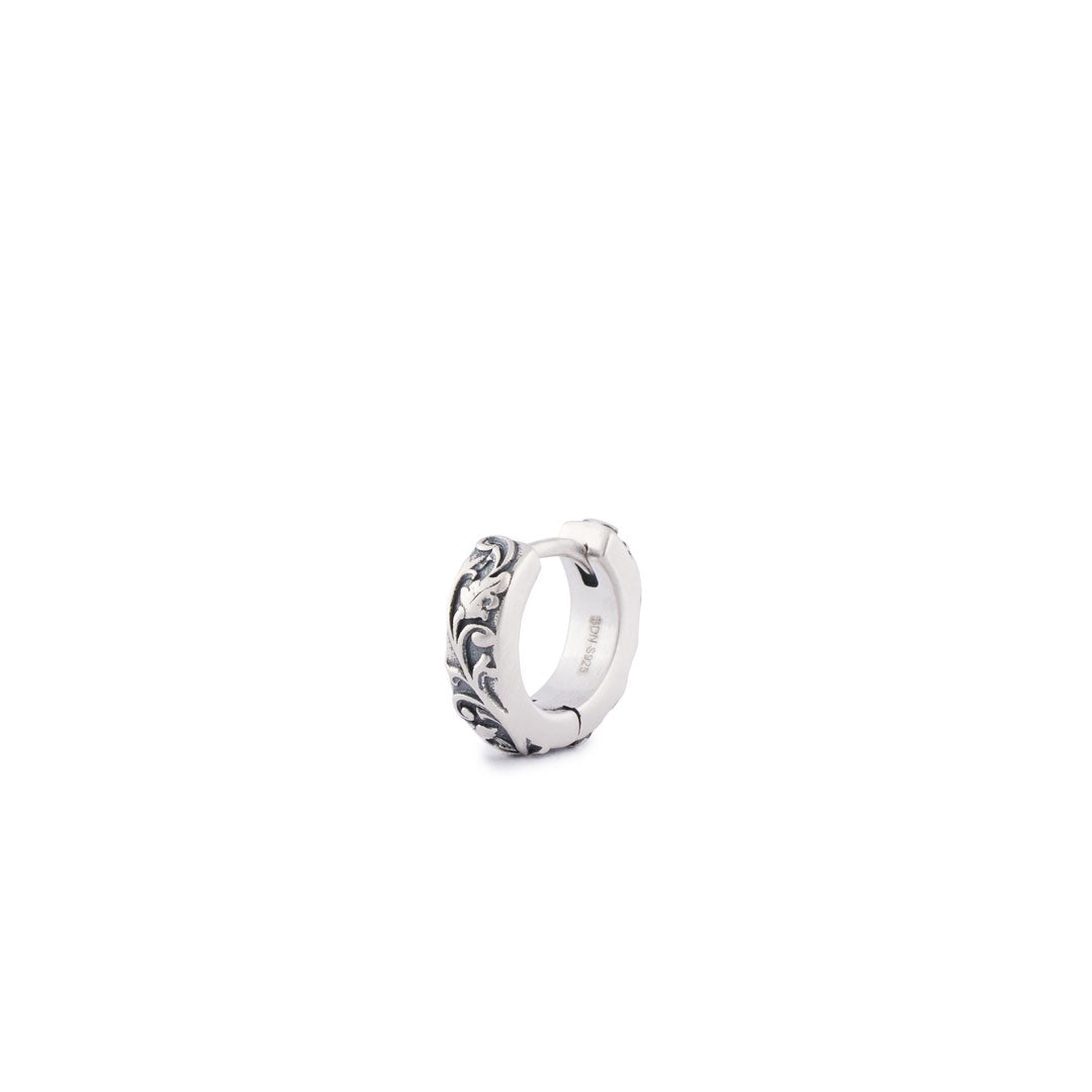 Silver hoop earring in a closed position with ornate floral detailing - Serge DeNimes