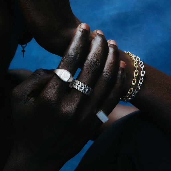 Model wearing multiple rings and bracelets